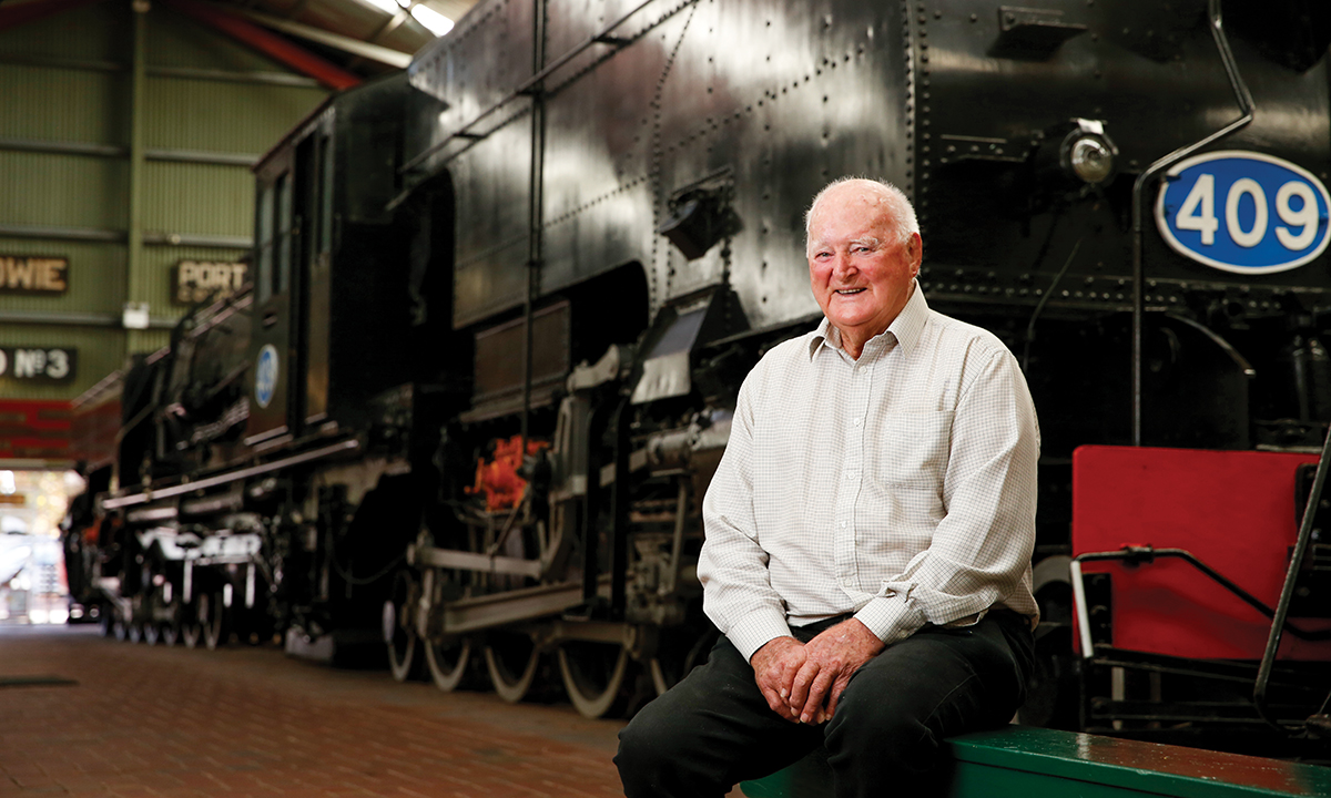 Young man looking out of train window on the historic steam engine